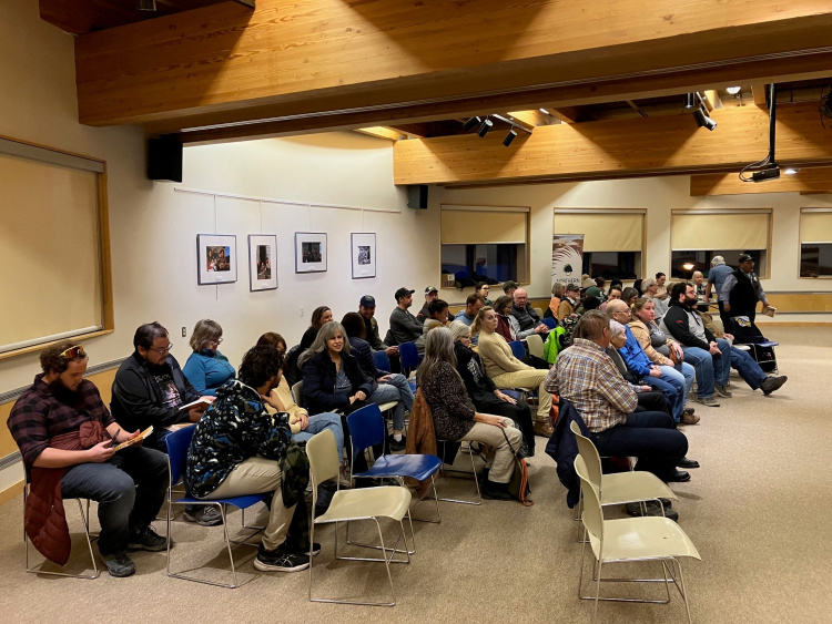 Image of a crowd of about 50 people seated to watch the book launch.